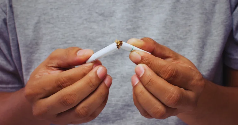 hands breaking a cigarette close up