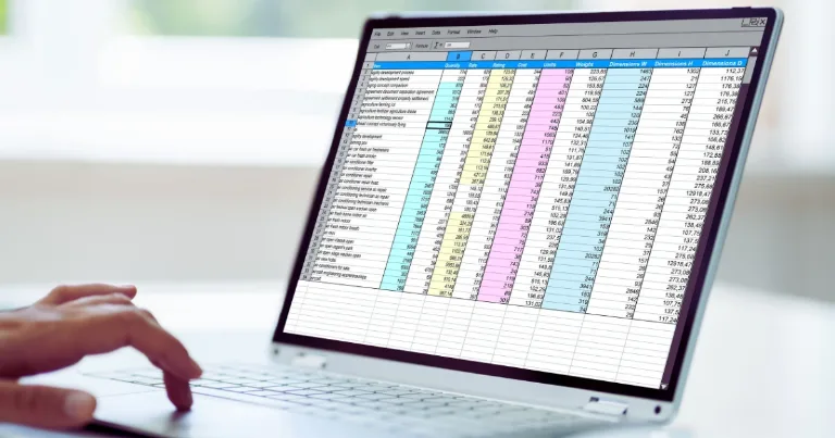 Laptop screen with Google Sheets open showing colored columns and rows