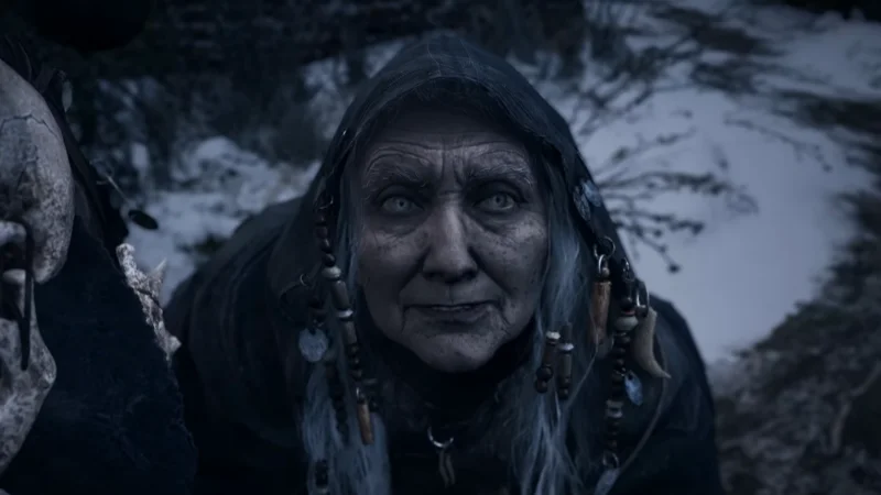 Close-up of an older woman with a cold stare in a snowy village, horror style