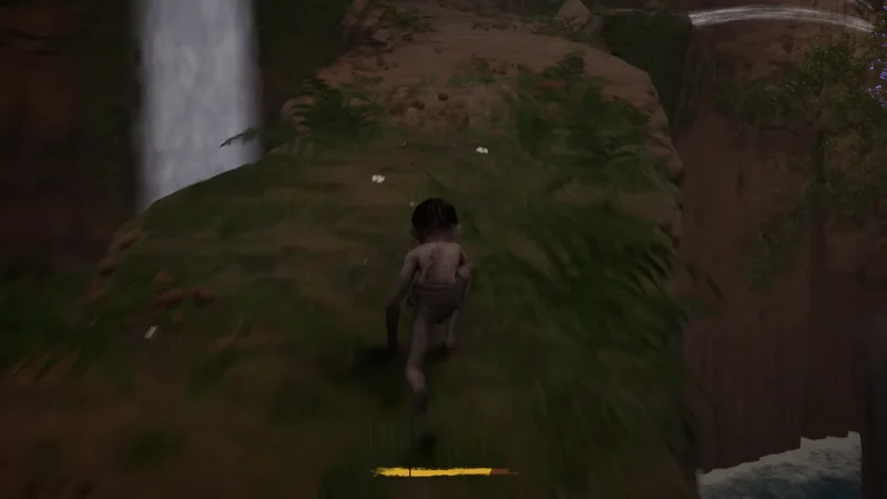 Gollum on a narrow cliff path beside a waterfall
