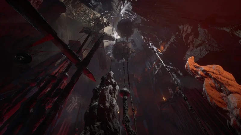 Gollum in a red-lit cavern with chains and scaffolds