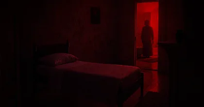 Illustration of Evy’s mother standing in a red-lit doorway beside an empty bed in Undertone.